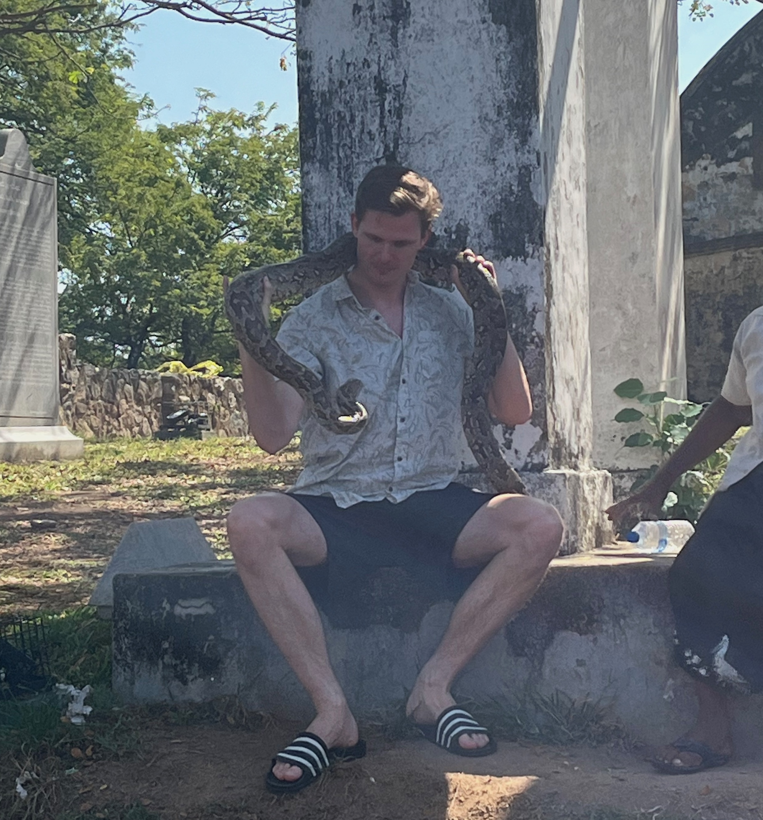 Photo showing Patrick holding an actual Python (snake) in his hands.